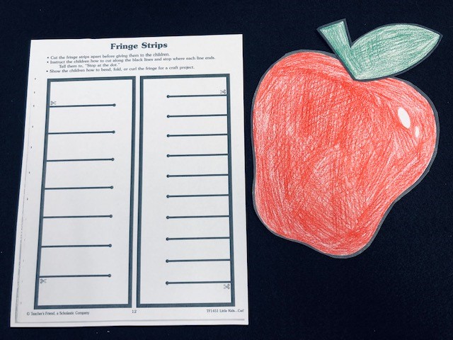 colored red apple and fringe sheet to cut