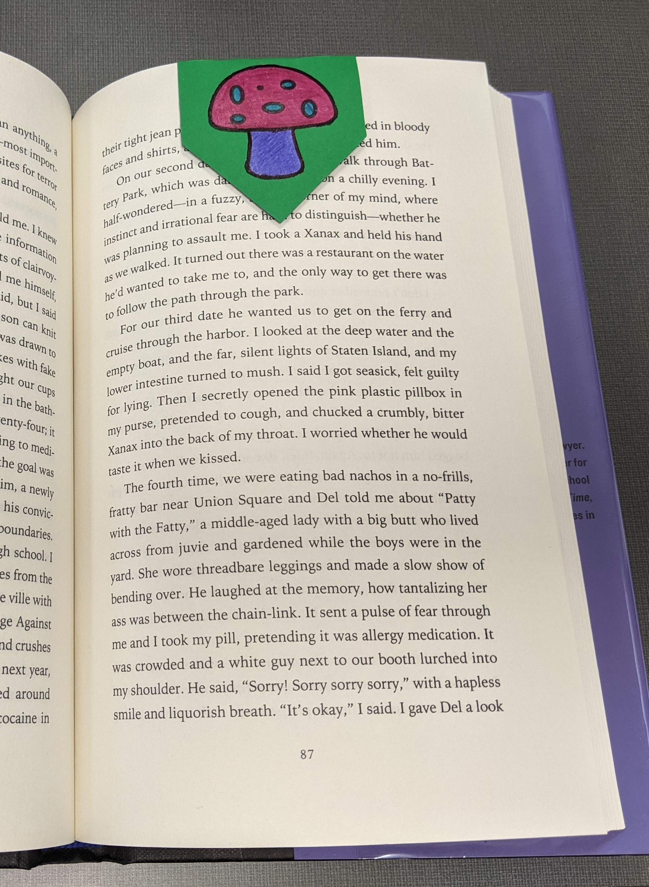 Open book with mushroom bookmark on topside of the right page.