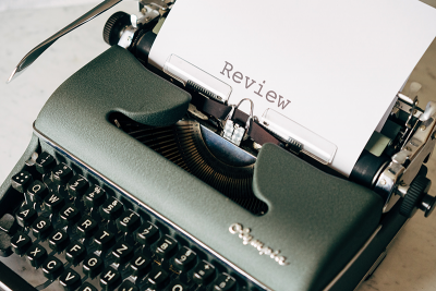 Typewriter image with the word "Review" on the paper
