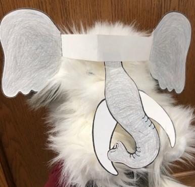 stuffed sheepdog wearing elephant headband