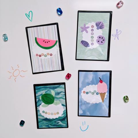 Four magnet frames on a white board; one has a slice of watermelon, one has sea shells, one has a sea turtle, and one has an ice cream cone.