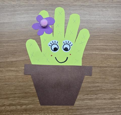 Photo of a paper cactus made out of a handprint outline.