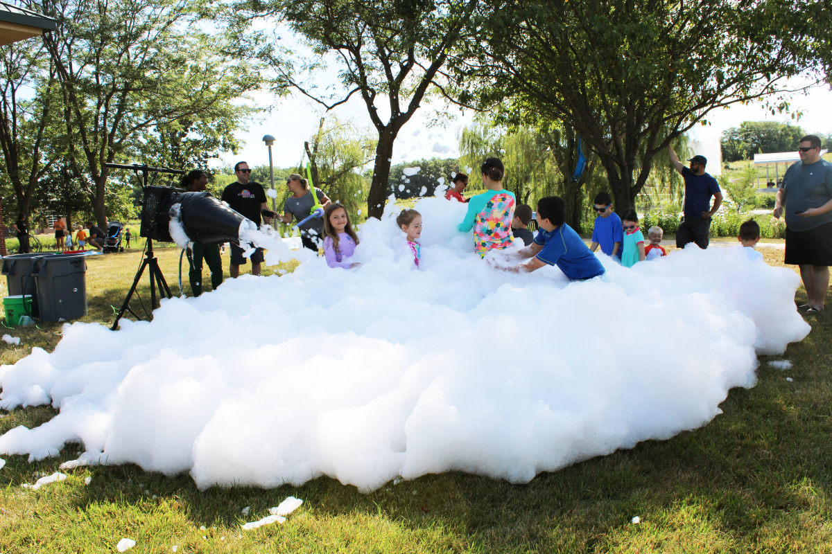 kids playing in pile of foamy bubbles