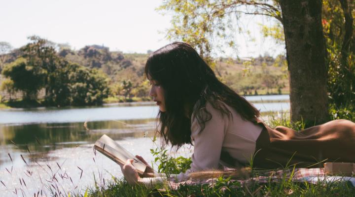 Woman reading on grass